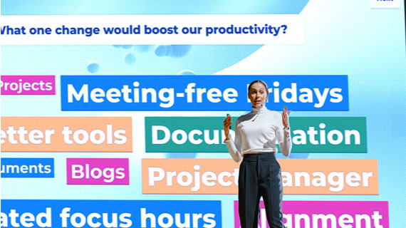 Female presenter standing in front of presentation